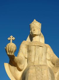 Statue against blue sky