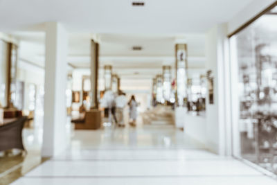 People walking in corridor of building