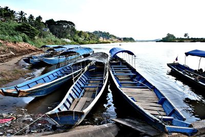 Boats moored in water against clear sky