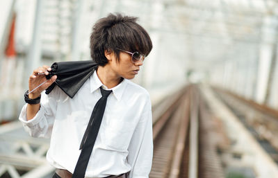 Man standing at railway bridge