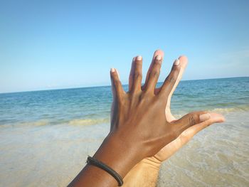 Extreme close up of couple hands on beach