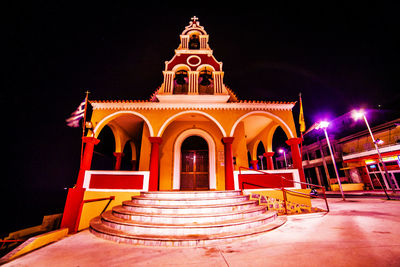 Illuminated building against sky at night