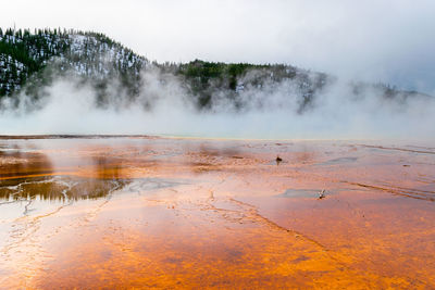 Scenic view of waterfall against sky