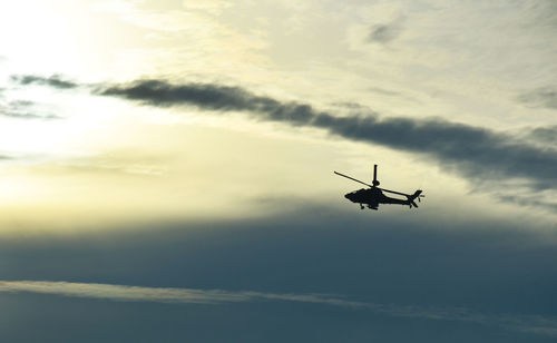 Low angle view of silhouette airplane against sky during sunset