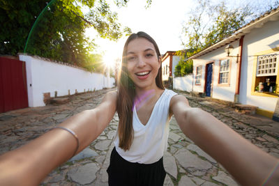 Young woman takes self portrait in the historic colonial town of tiradentes in minas gerais, brazil