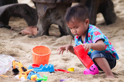 Boy playing with toy on sand