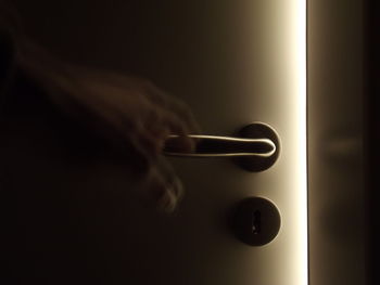 Close-up of human hand on door