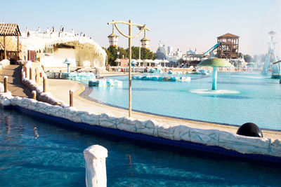 View of swimming pool by sea against clear sky