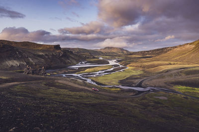 View of 4x4 about to cross river in wild valley in highlands iceland
