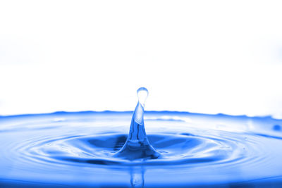 Close-up of water splashing against white background