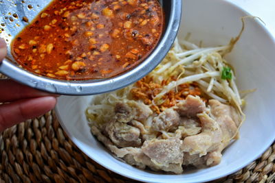 Close-up of hand holding food in bowl