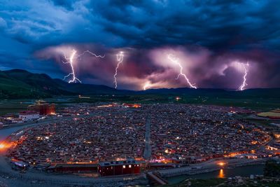 Lightning over cityscape at dusk