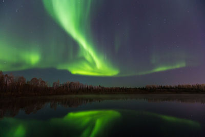 Scenic view of lake against sky at night