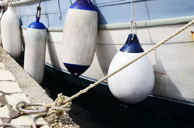 Close-up of buoys hanging on boat