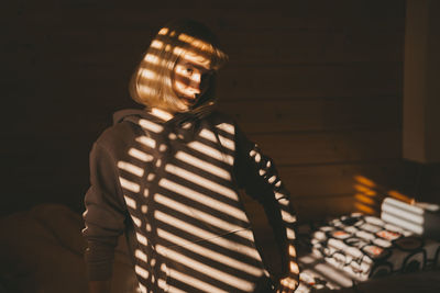 Woman standing against the wall