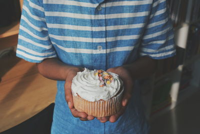 Midsection of man holding dessert