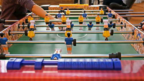 Midsection of person at foosball table