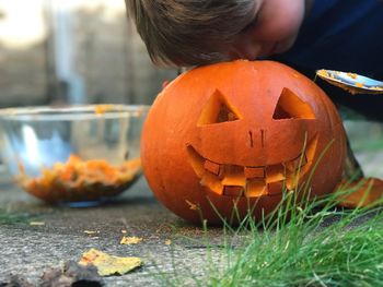 Close-up of boy peeking in jack o lantern