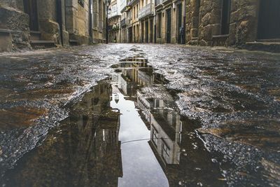 Reflection of built structures in puddle