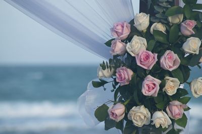 Close-up of rose bouquet against sea