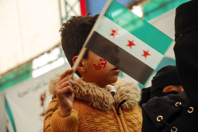 Boy holding flag during protest