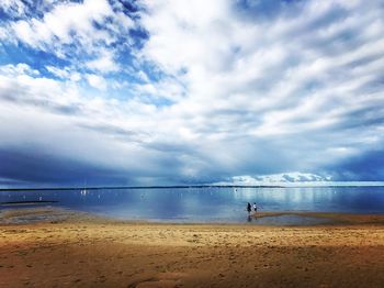 Man standing on beach against sky