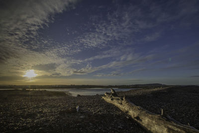 Scenic view of land against sky during sunset