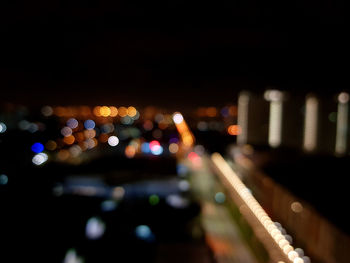 Defocused image of illuminated city street at night