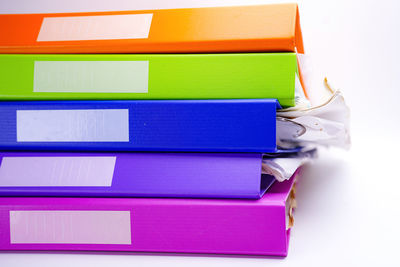 Close-up of colored pencils over white background