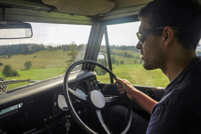 Close-up of man driving car