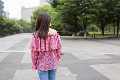 Rear view of woman standing in park