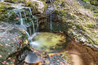 Winter. ice games in the fontanon of goriuda waterfall. friuli, italy.