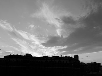 Exterior of silhouette buildings in town against sky