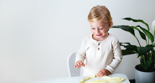 Cute girl,toddler playing with sticky slime indoors at home.early kid development