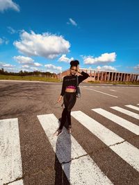 Portrait of woman standing on road