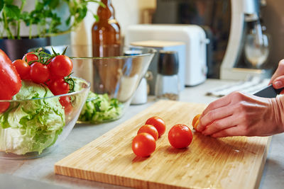 Woman prepare salad with cherry tomato