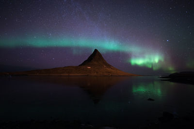 Scenic view of lake against sky at night