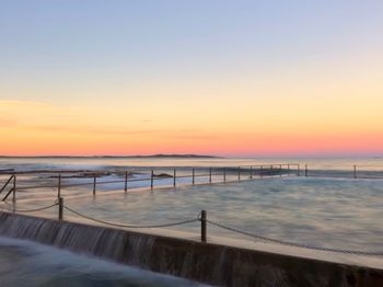 Scenic view of sea against clear sky during sunset