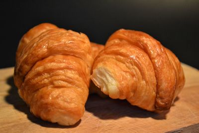 Close-up of bread on table against black background