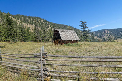 House on field against blue sky