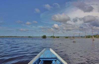 Cropped image of boat in lake against sky