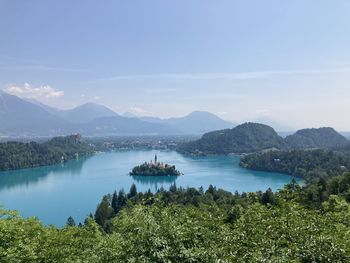 Scenic view of sea and mountains against sky