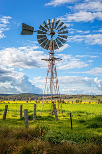 Low angle view of windmill against sky