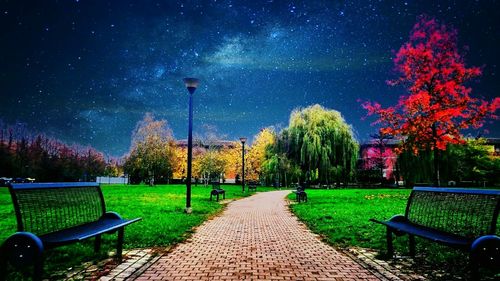 Empty playground against sky at night