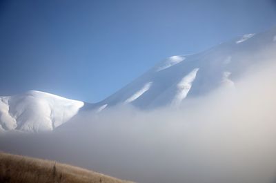 Scenic view of snowcapped mountains against sky