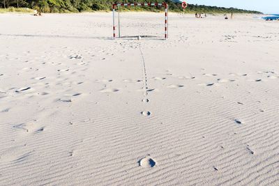 High angle view of footprints on sand at beach