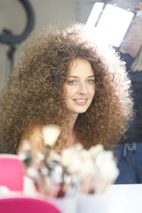 Portrait of young woman with curly hair