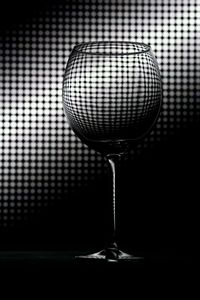 Close-up of wineglass against black background