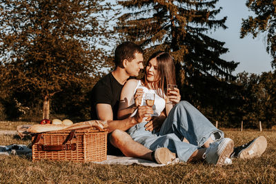 Side view of woman sitting on field