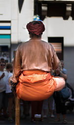 Rear view of magician performing on street